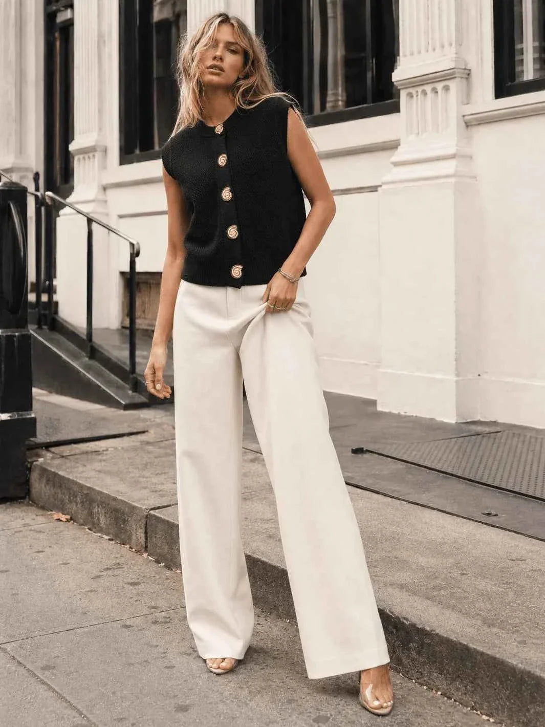 Black sleeveless button-front knit vest included in the three-piece outfit bundle