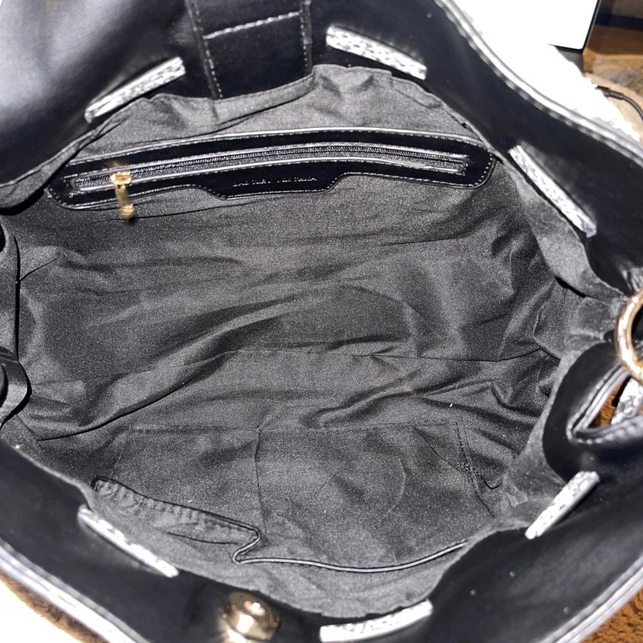 Interior of Badgley Mischka black tote with zip pocket