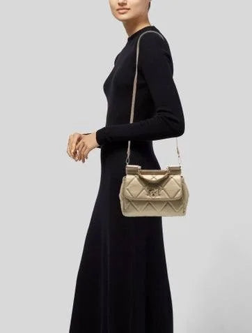 Model wearing Badgley Mischka champagne quilted top-handle crossbody bag
