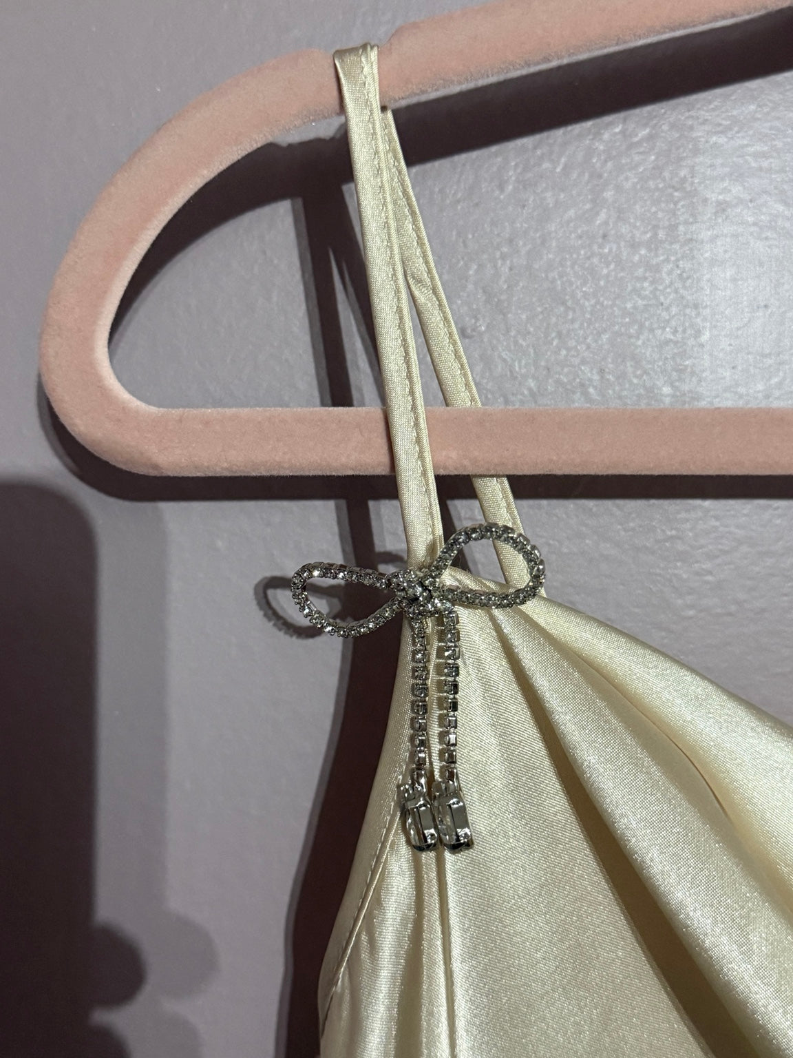 Rhinestone bow strap detail on Bebe satin mini dress