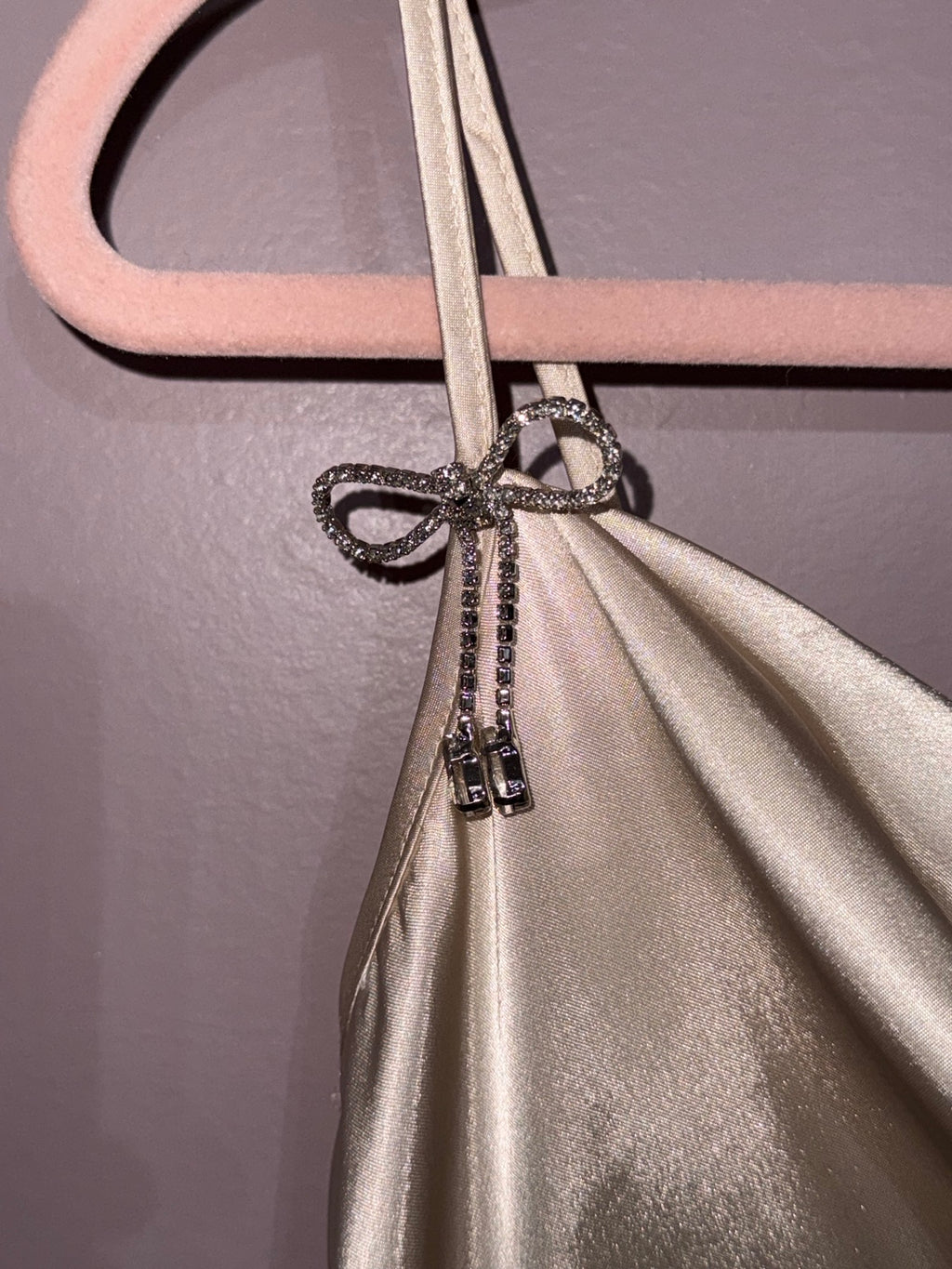 Rhinestone bow shoulder detail on Bebe satin mini dress