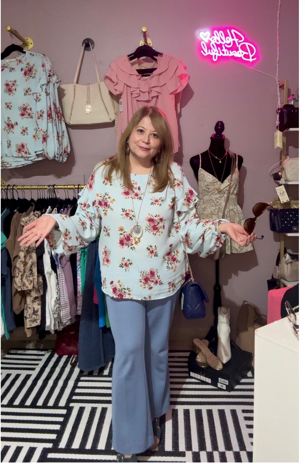 Caroline wearing the Vine & Love blue floral bell-sleeve blouse