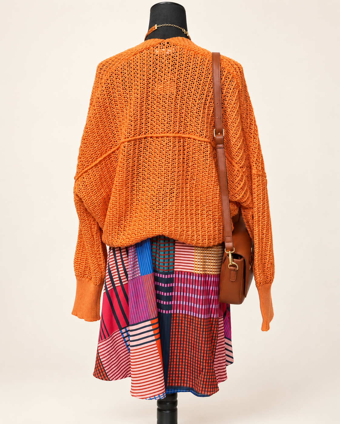 Umgee geometric-print dress and orange open-knit cardigan, back view; accessories sold separately.