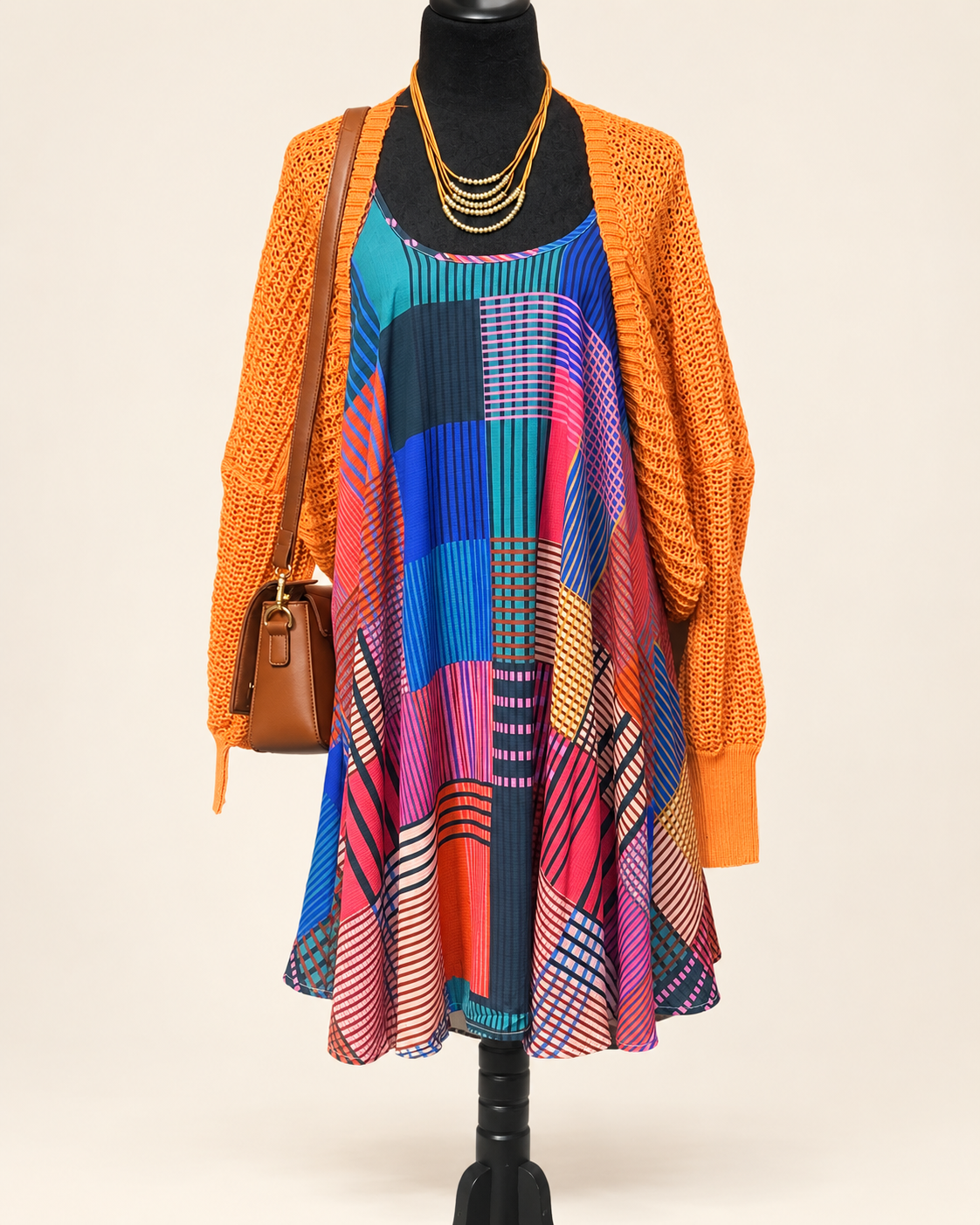 Umgee geometric-print dress and orange open-knit cardigan, front view; accessories sold separately.