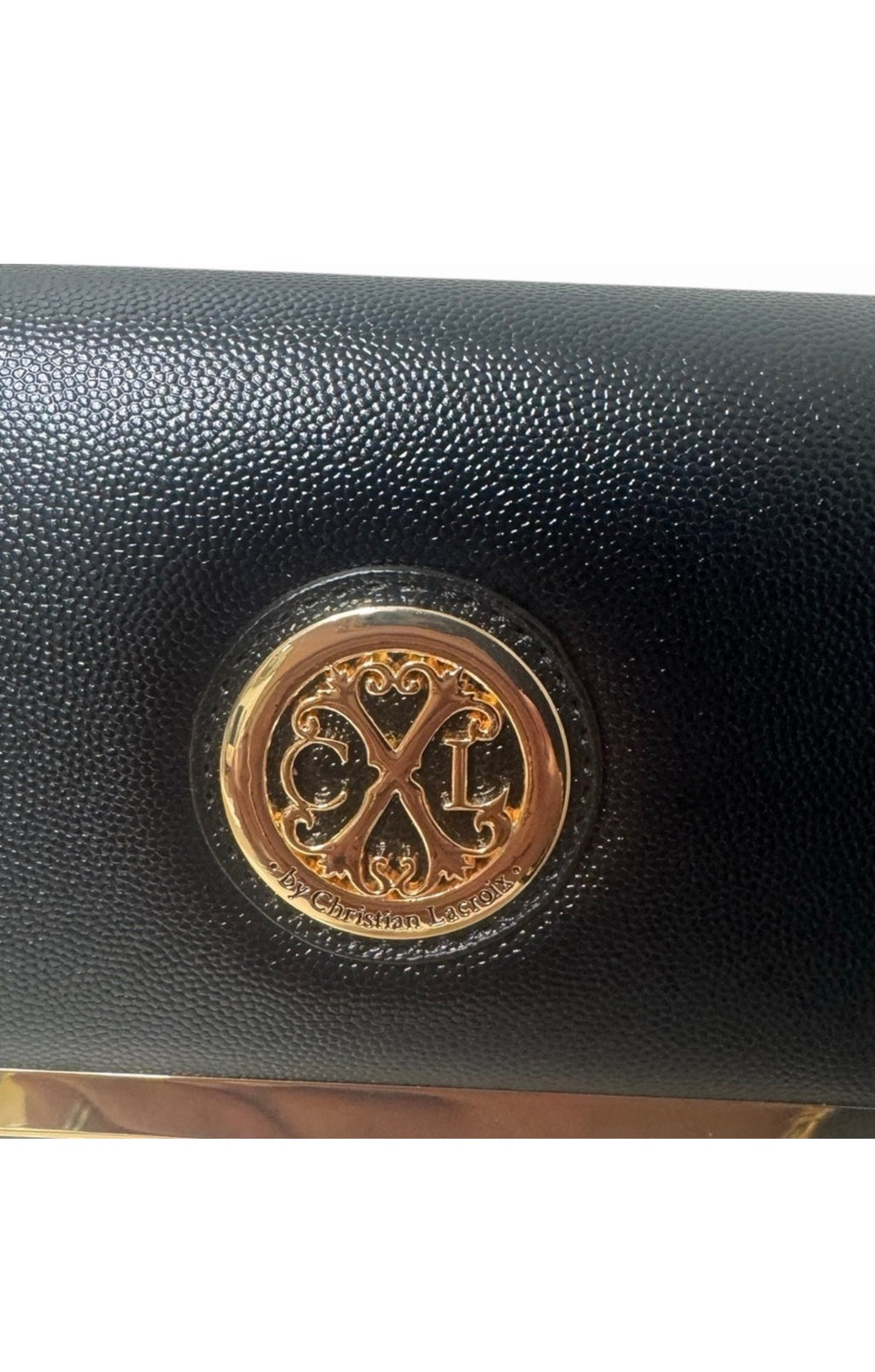 Close-up of CXL by Christian Lacroix gold-tone medallion