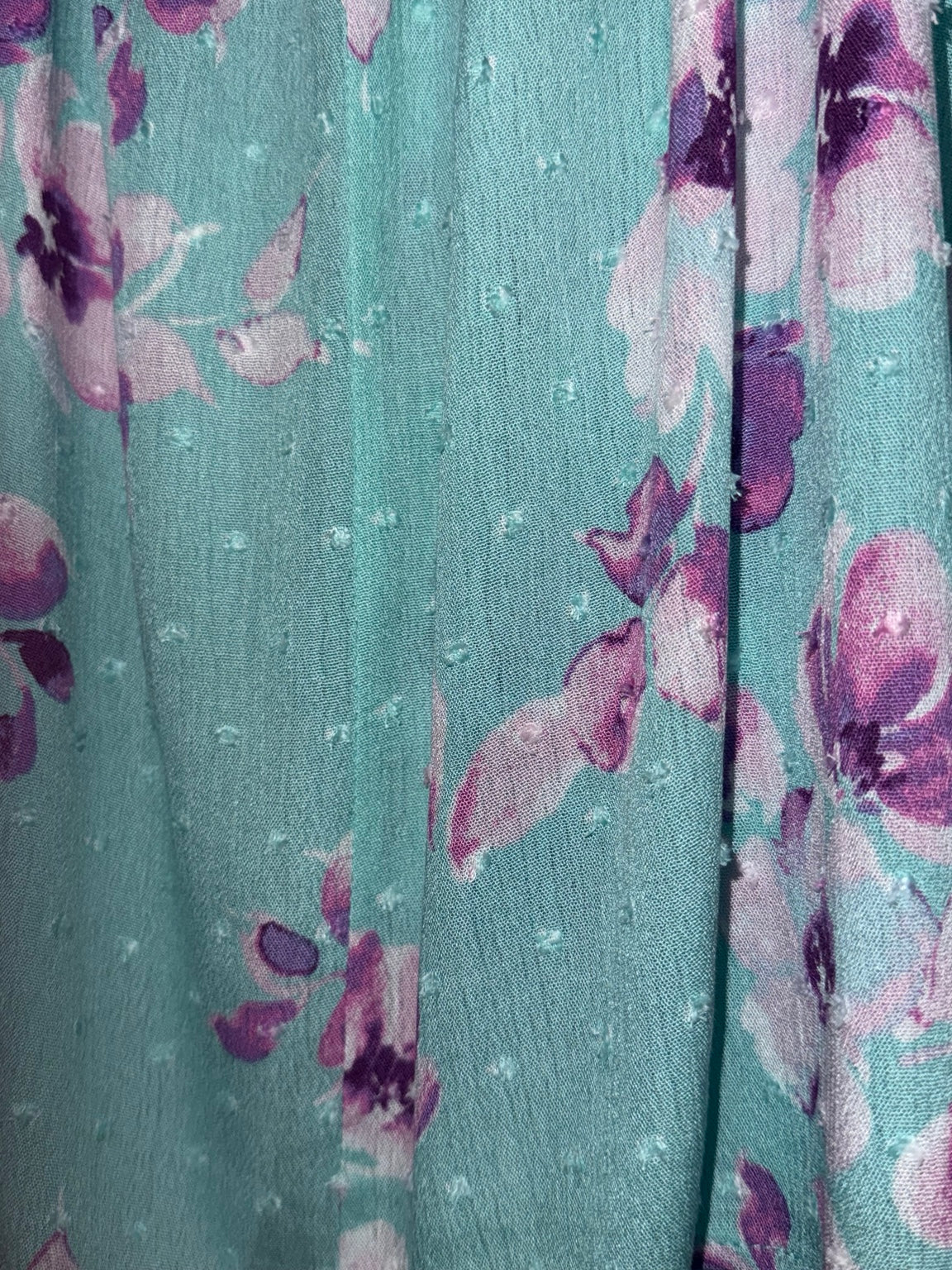 Close-up of aqua floral Swiss-dot fabric on Emily Wonder plus swing tank