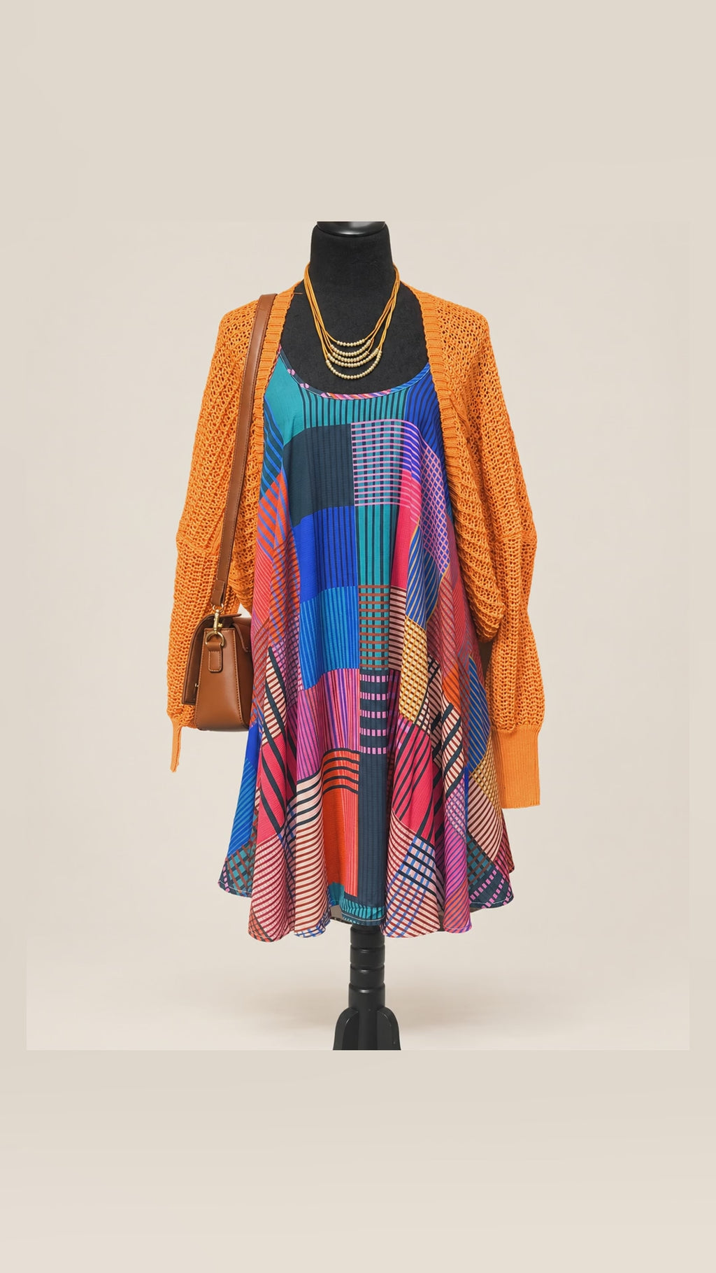 Caroline's Umgee geometric dress and orange cardigan outfit — front, side and back views. Handbag and necklace sold separately.
