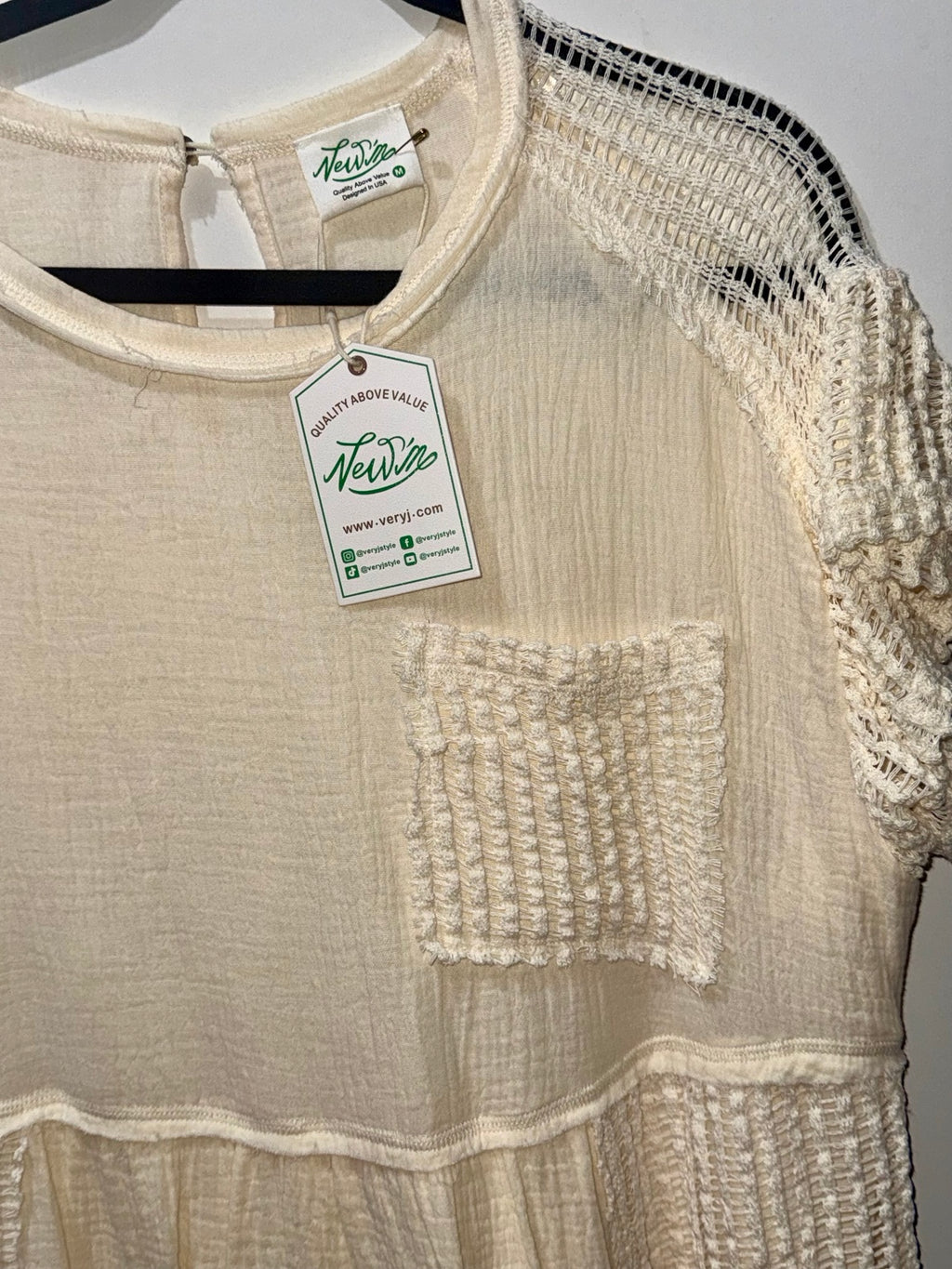 Close-up of crochet sleeve and front pocket detail