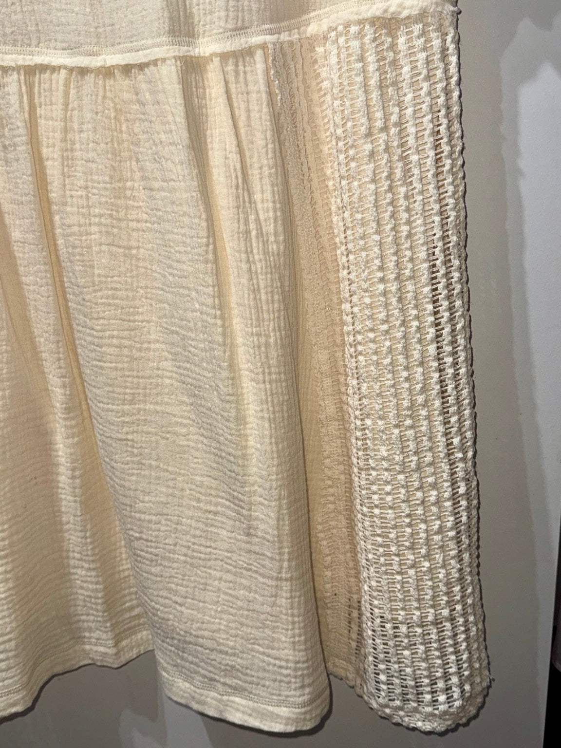 Close-up of crochet side panel and textured gauze fabric