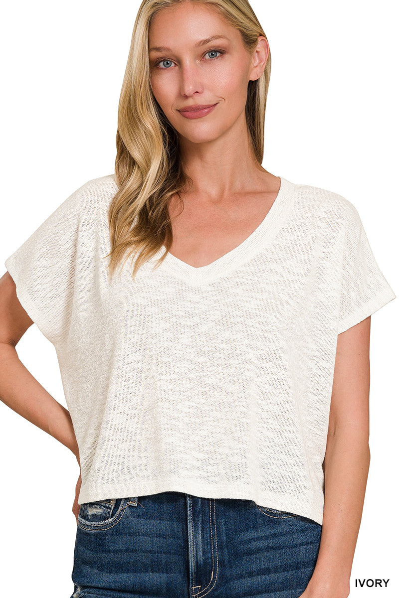 Model wearing the ivory Zenana HT-2361A textured V-neck short-sleeve top with jeans
